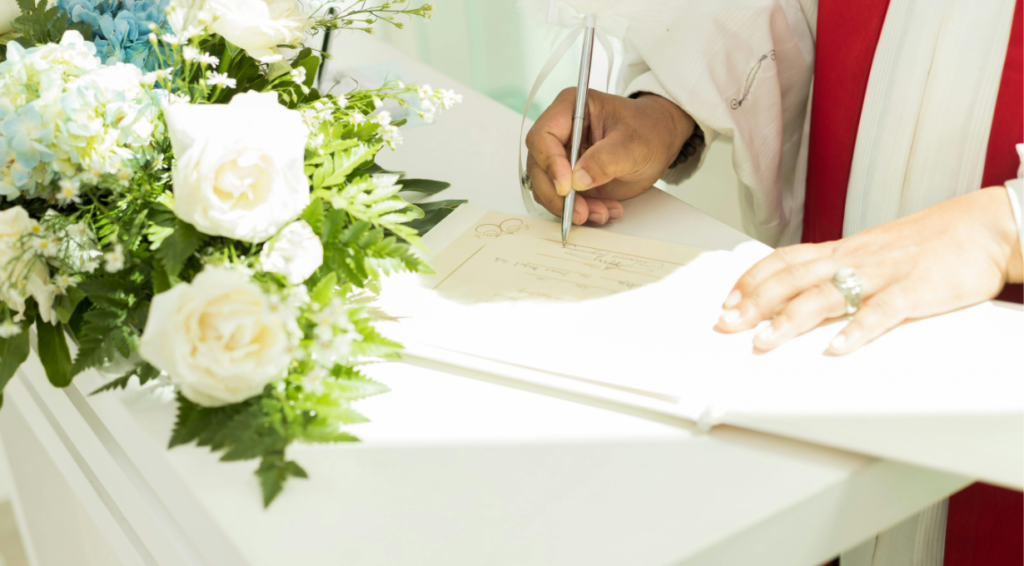 A man writing wedding wishes on a card for the couple