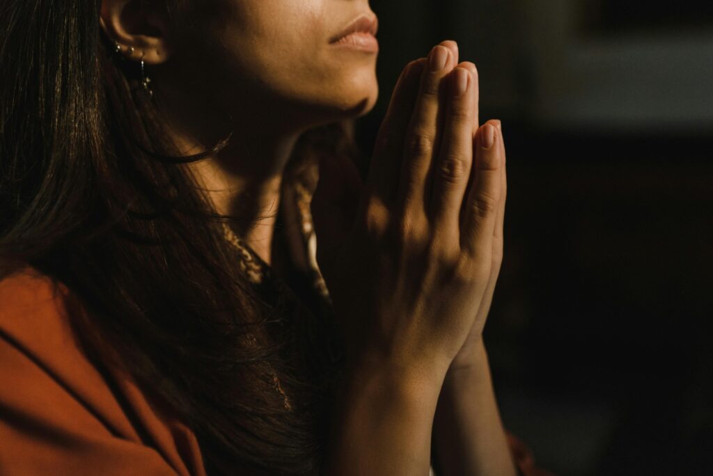 hands folded in prayer for anxiety relief and calm mind