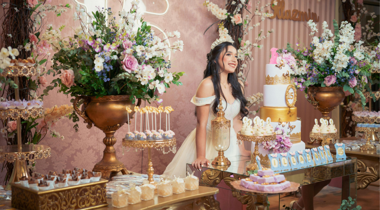 A teenage girl blowing out 16 wishes candles at her sweet sixteen birthday celebration.