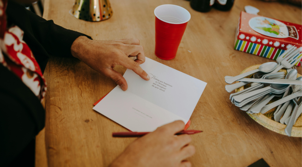 A woman writing happy birthday wishes for him